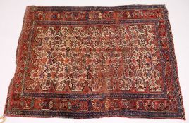 A PERSIAN RUG, early 20th Century, beige ground woven with stylized animals and birds, within a rust