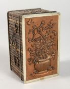 A JAPANESE TWO COLOUR SILVER BAMBOO DESIGN BOX, the lid with a vase of flowers and butterflies. 3ins