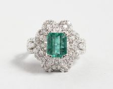A SUPERB 18CT WHITE GOLD, EMERALD SET, DIAMOND CLUSTER RING, central emerald 2.4cts.
