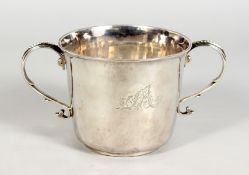 A GEORGE I TWO HANDLED CIRCULAR PORRINGER, open scroll handles with beadwork, engraved A & B on