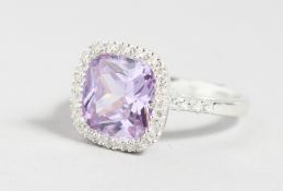 A SILVER RING with amethyst coloured stone.