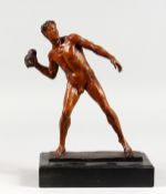 A PATINATED BRONZE FIGURE, male nude throwing a rock, on a marble base. 12ins high.