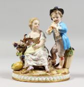 A GOOD 19TH CENTURY MEISSEN PORCELAIN GROUP, a young boy and a girl by his side with a goat, on an