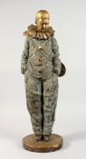 A LARGE GILT BRONZE PIERROT carrying a mandolin on his back, on a circular base. 23ins