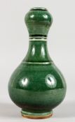 A SMALL CHINESE GREEN GLAZED PORCELAIN GARLIC NECK VASE. 7ins high.