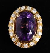 A SUPERB 18CT YELLOW GOLD LARGE AMETHYST CENTRAL STONE RING, surrounded by diamonds.