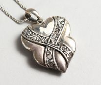 A SILVER, MALACHITE, AND ENAMEL PENDANT on a chain.