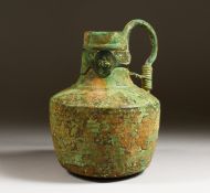 A BYZANTINE BRONZE FLASK with three sheet metal medallions decorating the neck. 8ins high.