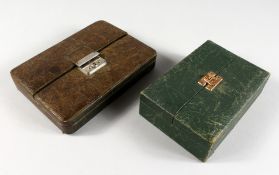 TWO FOLDING LEATHER JEWELLERY CASES. 6ins and 7ins high.