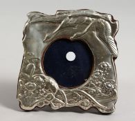 A SILVER PHOTOGRAPH FRAME with flowers and flying storks. 4ins x 4ins.