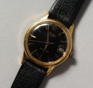 A GENTLEMAN'S MUDU WRISTWATCH with leather strap.