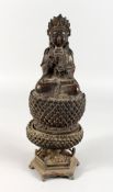 A CAST METAL EASTERN FEMALE DEITY, seated on a lotus base. 11ins high.