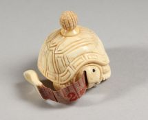 A CARVED BONE TORTOISE TAPE MEASURE.