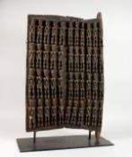 A CARVED THREE PIECE DOOR on a stand. 29ins high x 17ins wide.