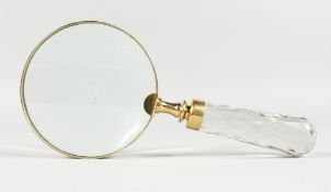 A MAGNIFYING GLASS with glass handle.
