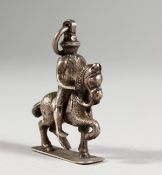 A SMALL CAST SILVER PENDANT/CHARM, modelled as a man on horseback. 1.5ins high.