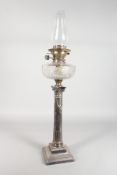A GOOD CORINTHIAN COLUMN OIL LAMP with glass reservoir.