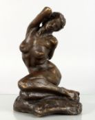 A BRONZE CASTING OF A SEATED FEMALE NUDE. 10.5ins high.