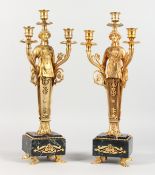 A PAIR OF EMPIRE REVIVAL GILT BRONZE FIGURAL TWIN BRANCH, THREE LIGHT CANDELABRA, on marble bases.