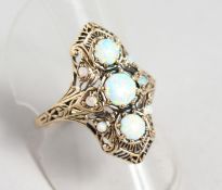 A 9CT GOLD AND GILSON OPAL RING.