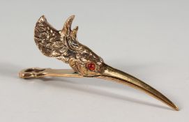 A PLATED SNIPE HEAD PAPER CLIP with glass eyes.