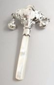 A SILVER AND MOTHER-OF-PEARL BABIES' RATTLE.