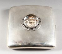 A PLAIN SILVER CIGARETTE CASE, inset with an Essex crystal of three cats. Birmingham 1925.