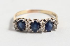 A 9CT YELLOW GOLD, DIAMOND AND THREE STONE SAPPHIRE RING.