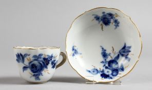 A SMALL MEISSEN CUP AND SAUCER, painted in blue and gilt with sprays of flowers. Saucer: 4ins