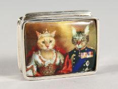 A SILVER BOOK SHAPED PILL BOX, the lid with an enamel of two cats.. 1ins diameter.