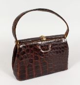 A WADYBACK CROCODILE HANDBAG.