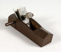 A JAPANESE BRONZE MINIATURE WOODWORKING PLANE. 3.5ins long.