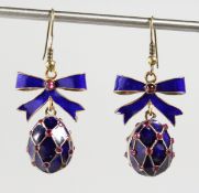A PAIR OF RUSSIAN SILVER AND ENAMEL EGG AND BOW pendant earrings.