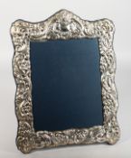 A LARGE SILVER PHOTOGRAPH FRAME with scrolls and flowers. 15ins high x 11ins wide. London 1984.