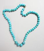 A TURQUOISE BEAD NECKLACE with gold clasp.