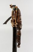 A RARE TRIBAL CARVED WOOD AND METAL WEAPON. 23ins long.