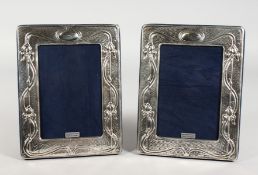 A PAIR OF ART NOUVEAU STYLE SILVER PHOTOGRAPH FRAMES. 7.5ins high.