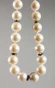 A PEARL NECKLACE, interspersed with small diamonds, white a white gold clasp. 17ins long.
