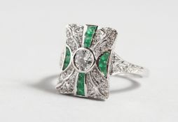 A GOOD SILVER GREEN AND WHITE CZ CLUSTER RING.