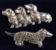 TWO SILVER DACHSHUND DOG BROOCHES.