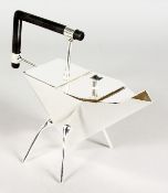 IN THE MANNER OF CHRISTOPHER DRESSER, a silver plated triangular teapot.