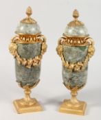 A PAIR OF LOUIS XVITH MARBLE AND ORMOLU URNS AND COVERS with pineapple finials and fruiting vines.