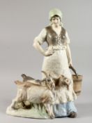 A LARGE AUSTRIAN POTTERY GROUP of a young girl with two goats. 21ins high.