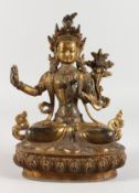 A THAI GILT BRONZE SEATED DEITY, inlaid with semi-precious stones. 8.5ins high.