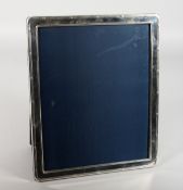 A SILVER PHOTOGRAPH FRAME with reeded edges. 11.5ins high x 9.5ins wide. London 1973.
