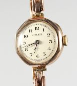 A LADIES' 9CT GOLD WRISTWATCH with an octagonal face, in a Rolex box.