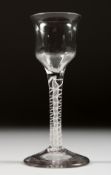 A GEORGIAN WINE GLASS with semi fluted bowl and white twist stem. 5.5ins high.