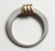 A CARTIER SCARF CLIP in a Cartier red box.