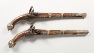 A PAIR OF EARLY 18TH CENTURY TURKISH SILVER MOUNTED FLINTLOCK PISTOLS, steel barrels and walnut