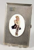 A LARGE ENGINE TURNED SILVER CIGARETTE CASE with an oval enamel plaque GLAMOUR. Birmingham 1928.